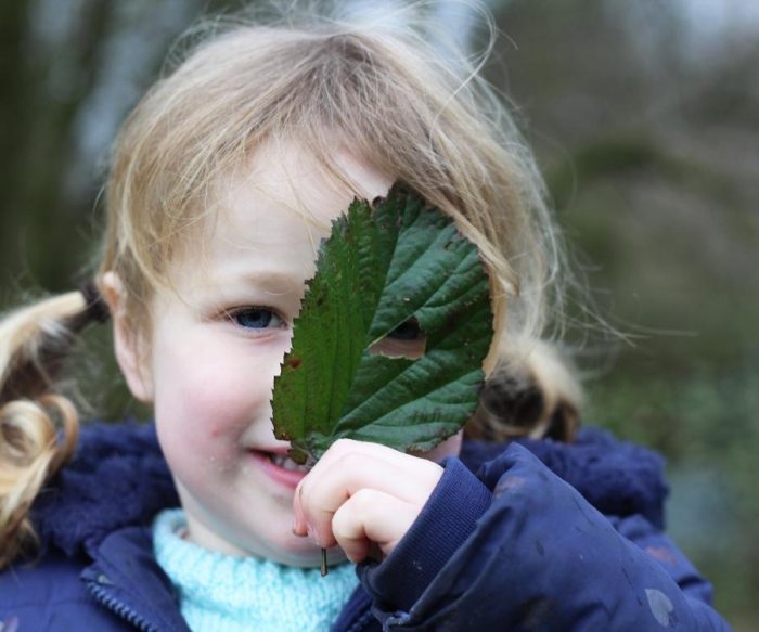 Forest School girl with leaf